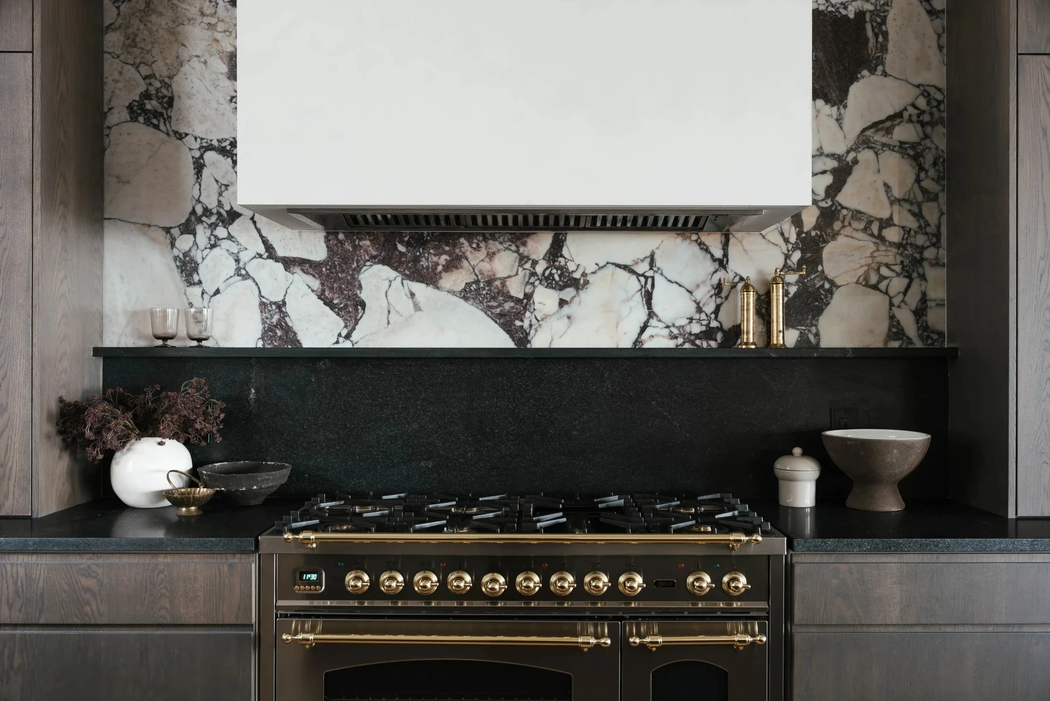 Marble backsplash and brass range details