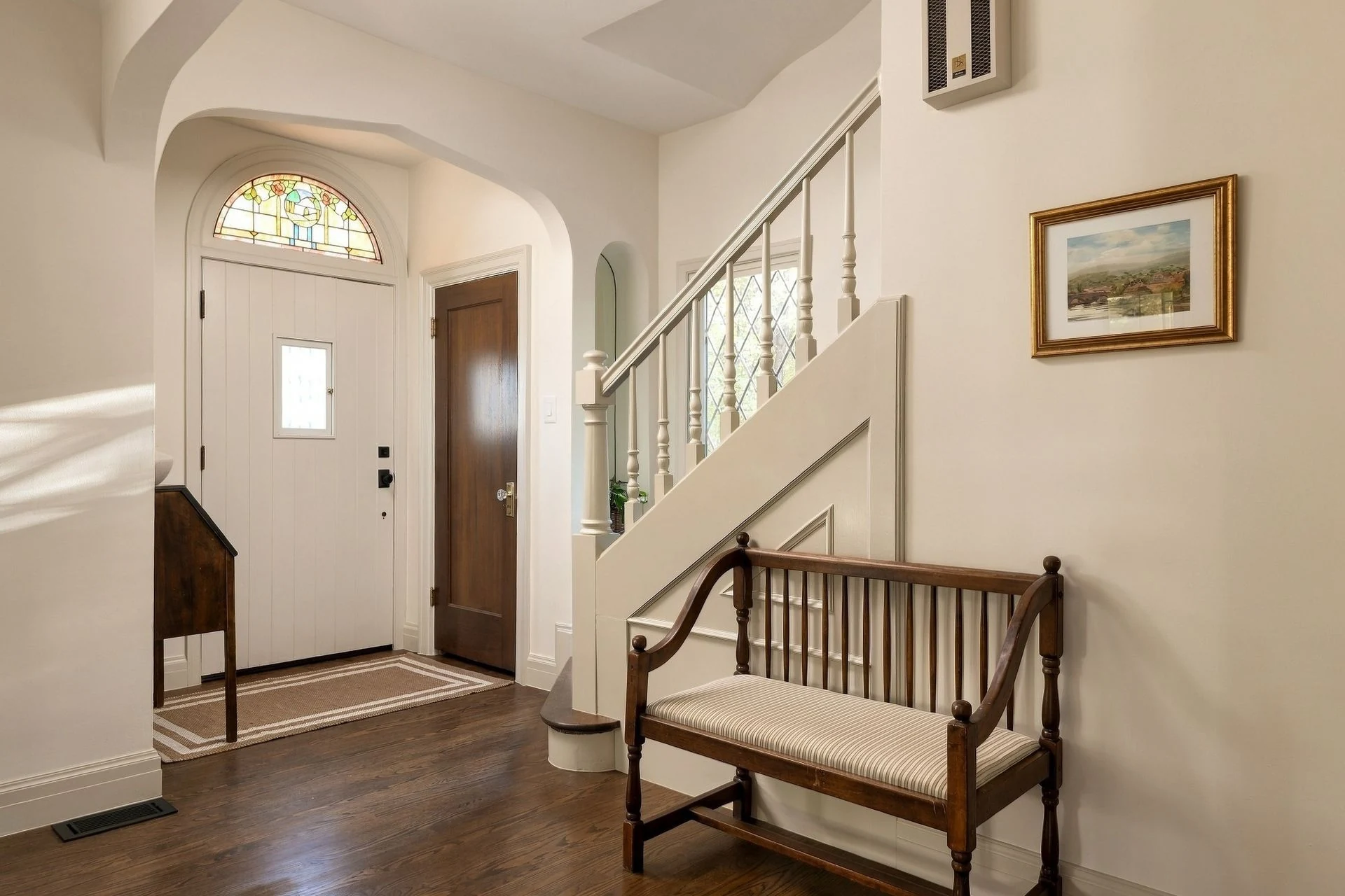 Entry hall with stained-glass transom and staircase
