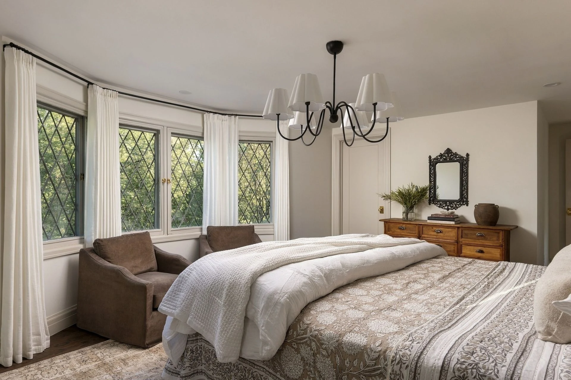 Primary bedroom with diamond-grid windows